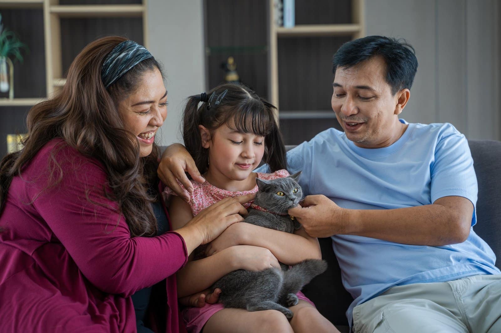 Happy family with cute cats resting at home,Family with cats.