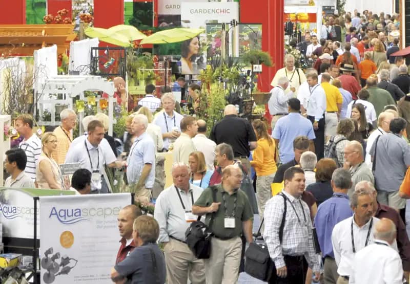 Trade show floor with booths and attendees, similar to an exhibition-hall layout