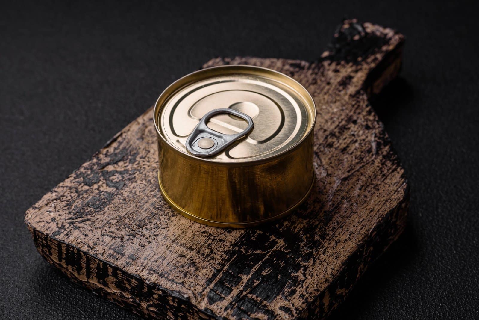 Round metal can with canned fish or meat with a key